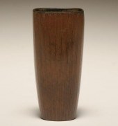 A ribbed vase in a brown glaze