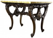 A ROCOCO STYLE CARVED MAHOGANY