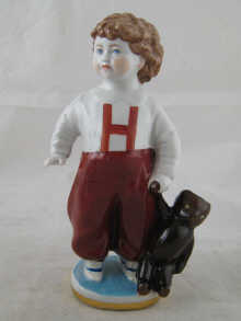 A Russian ceramic figure of a boy