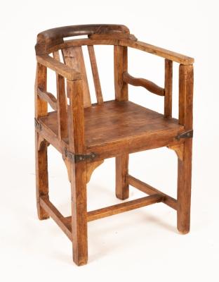 A rustic elm chair of tub shape,