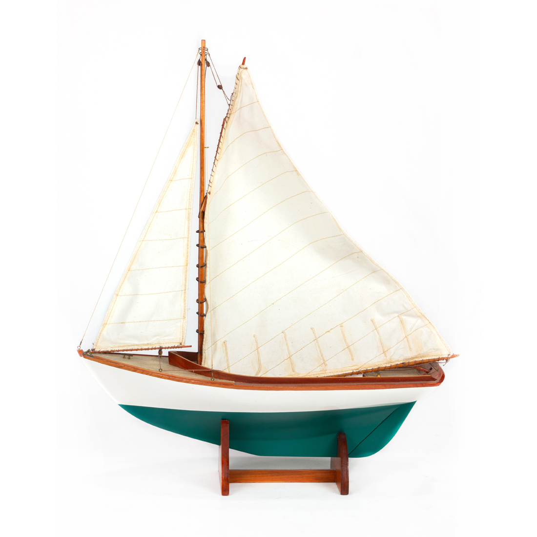A SCALE MODEL SAILBOAT ON STAND A