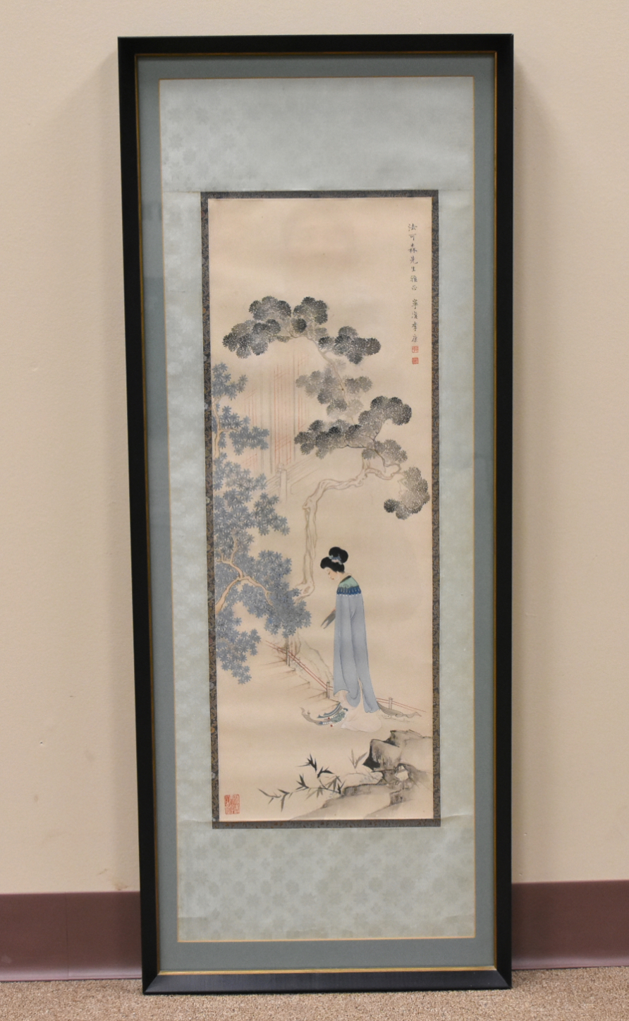 A SCROLL PAINTING OF A WOMAN IN