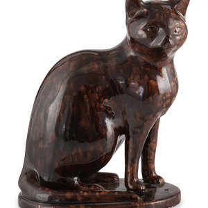 A Seated Cat Figure In Rockingham