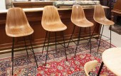 A SET OF FOUR EAMES BAR STOOLS