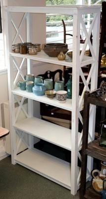 A set of open shelves with X-shaped
