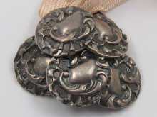 A set of six silver buttons