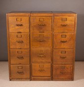 A SET OF THREE OAK FOUR-DRAWER