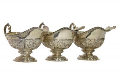 A set of three silver sauce