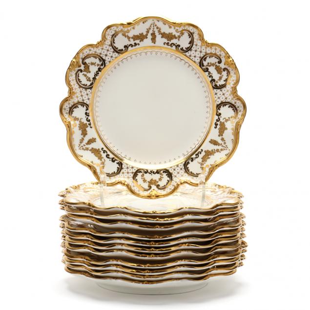 A SET OF TWELVE GOLD ENCRUSTED