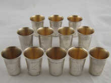 A set of twelve white metal tests
