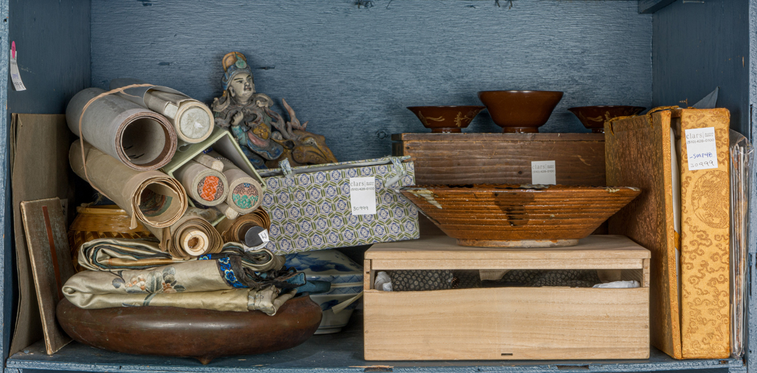 A SHELF OF ASIAN DECORATIVE ARTS