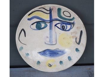 A signed plate with facial