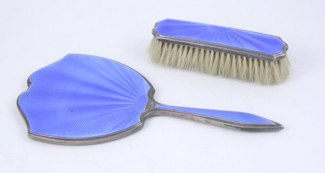 A silver and blue enamel hand