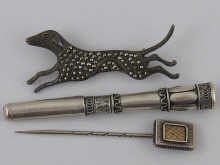 A silver and marcasite hound brooch