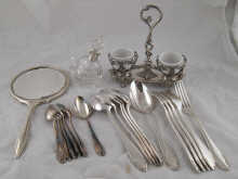 A silver backed hand mirror a white