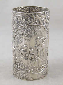 A silver beaker with embossed