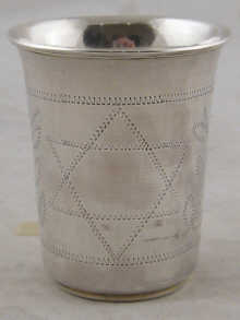 A silver beaker with engraved