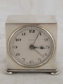 A silver bedroom alarm clock by