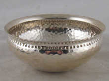 A silver bowl with hammered