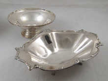A silver bread dish with cast