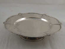 A silver cake plate on stand