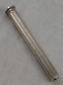 A silver cased smoker's companion