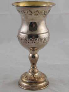 A silver ceremonial beaker marked