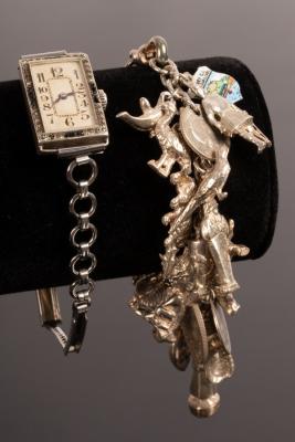 A silver charm bracelet hung with a
