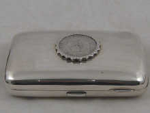 A silver cigar case measuring