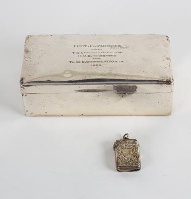 A silver cigarette box, marks
