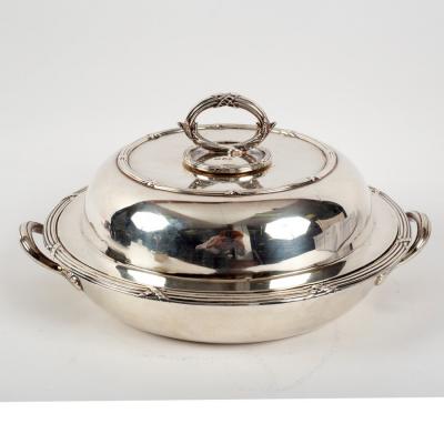 A silver circular vegetable dish