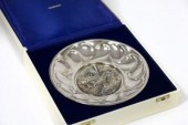 A silver commemorative plate,