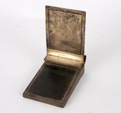 A silver desktop notepad clip,