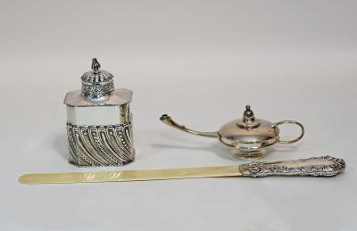 A silver embossed tea caddy and