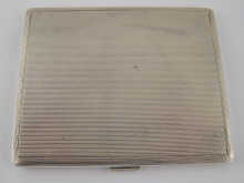 A silver engine turned cigarette