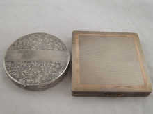 A silver engine turned compact with
