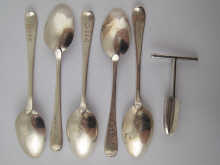 A silver four bladed apple corer