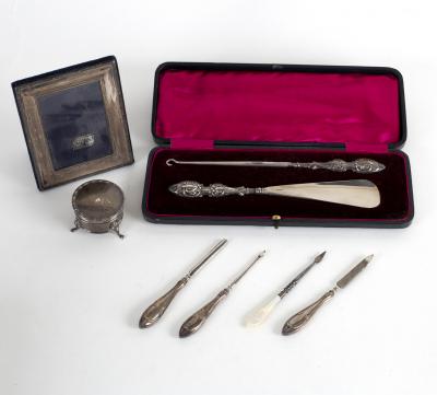 A silver handled shoe horn and