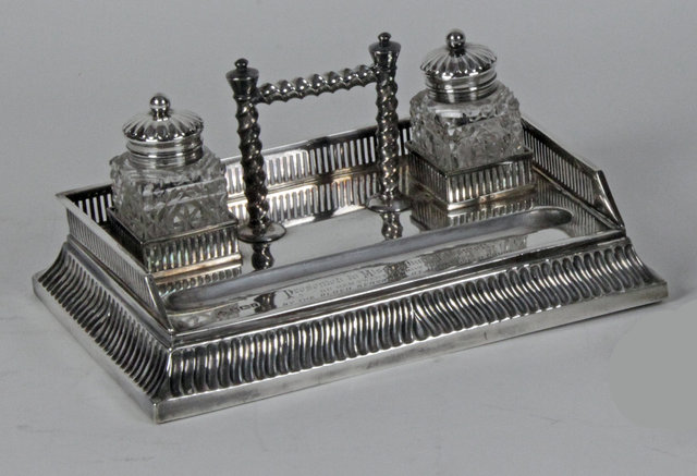 A silver ink stand and pen tray