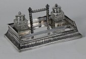 A silver ink stand and pen tra