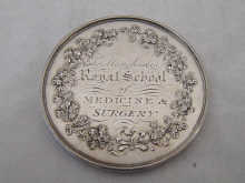 A silver medical medal from the