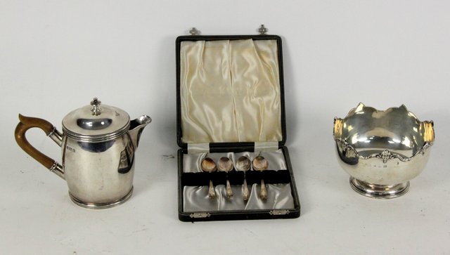 A silver milk jug and cover