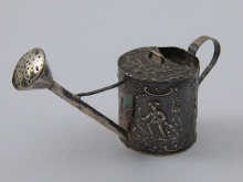 A silver model of a watering can
