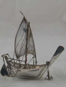 A silver model of an Arab dhow with
