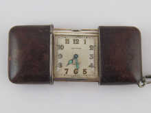 A silver Movado travelling watch