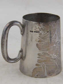 A silver mug of tapering form