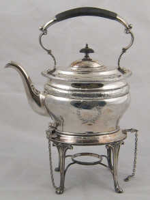 A silver oval kettle on stand