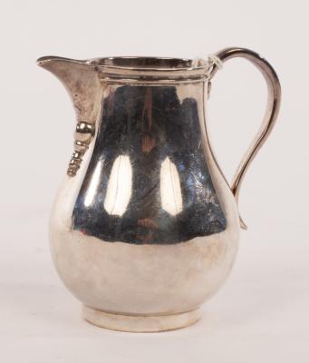 A silver pear-shape cream jug,