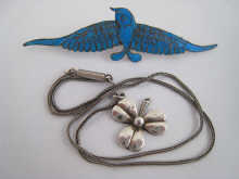 A silver pendant designed as a