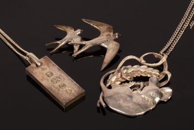 A silver pendant modelled as a